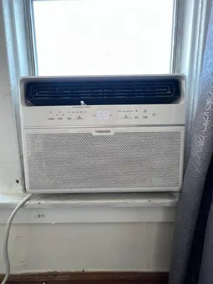 a air conditioner sitting in a window sill at Sleek Studio Near Downtown LA • AC • WiFi • Snacks in Los Angeles