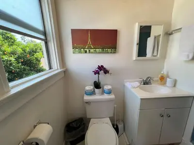 a bathroom with a toilet and a sink and a window at Sleek Studio Near Downtown LA • AC • WiFi • Snacks in Los Angeles