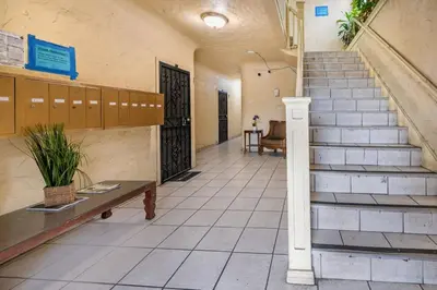 a hallway of a building with stairs and a bench at Sleek Studio Near Downtown LA • AC • WiFi • Snacks in Los Angeles