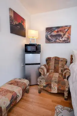 a room with a bed and a couch and a chair at Cozy Studio Near Downtown LA with AC WiFi and Snacks in Los Angeles