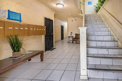 a hallway of a building with a staircase and a bench at Lovely Studio Near Downtown LA with AC WiFi and Snacks in Los Angeles