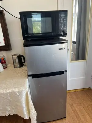 a microwave sitting on top of a refrigerator at Comfy Studio Near Downtown LA with AC WiFi and Snacks in Los Angeles
