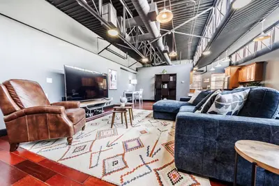 a living room with couches and a flat screen tv at Long Beach Apartment - 10 Min Walk to the Beach! in Long Beach