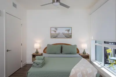 a bedroom with a bed and two lamps and a window at Beautiful NEW apartment in SM! in Los Angeles