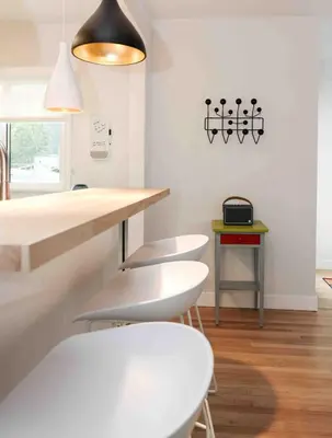 a kitchen with two white stools and a table at Lalaland Bungalow in Burbank