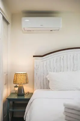 a bedroom with a bed and a lamp on a table at Foothills LA Hideaway Patio Lounge Work-Friendly in Glendora