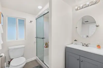 a bathroom with a toilet and a sink and a mirror at Foothills LA Hideaway Patio Lounge Work-Friendly in Glendora