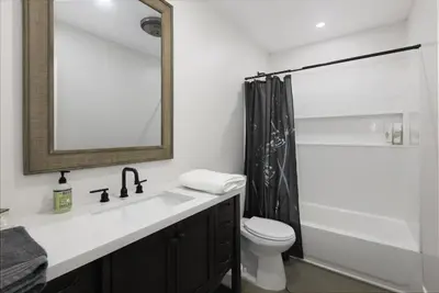 a bathroom with a sink and a toilet and a mirror at Bear Mountain Getaway in Big Bear Lake