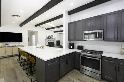 a kitchen with wooden cabinets and a white counter top at Bear Mountain Getaway in Big Bear Lake
