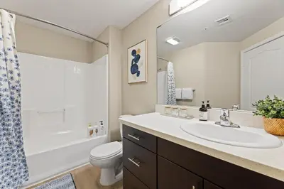 a bathroom with a sink and a toilet and a shower at Great 2bd 2bath in MdR! Free parking and pool! in Los Angeles