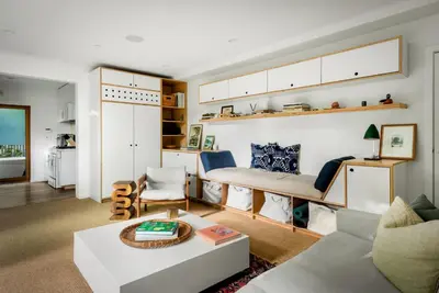 a living room with a bed and a couch at Abbot Kinney 2-Story Bungalow with Sauna and Plunge in Los Angeles