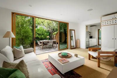a living room with a white couch and a table at Abbot Kinney 2-Story Bungalow with Sauna and Plunge in Los Angeles
