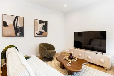a living room with a couch and a tv at Luna View LA in Los Angeles
