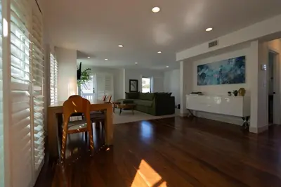 a living room with a table and a couch at Venice Beach Townhouse in Los Angeles