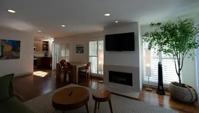 a living room with a fireplace and a tv at Venice Beach Townhouse in Los Angeles