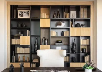 a room with a white chair in front of a book shelf at Luxurious Malibu 6BR Estate with Pool, Theatre, Views in Malibu Beach