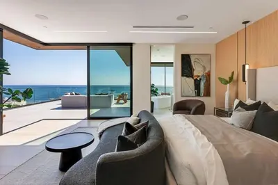 a bedroom with a bed and a view of the ocean at Luxurious Malibu 6BR Estate with Pool, Theatre, Views in Malibu Beach