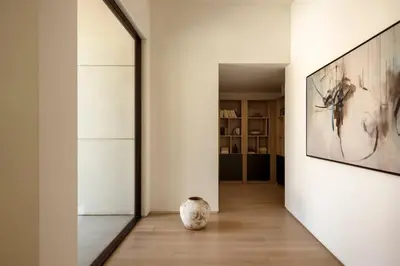 a hallway with a large painting on the wall and a vase at Malibu Coastal Paradise with Pool, Spa and Tennis Court in Malibu