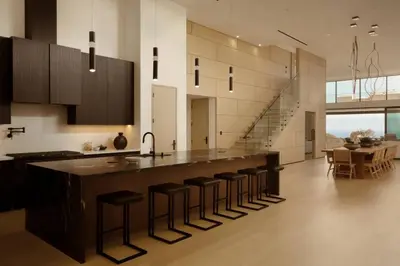 a kitchen with a large island with bar stools at Malibu Coastal Paradise with Pool, Spa and Tennis Court in Malibu