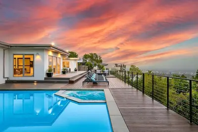 a house with a swimming pool on a deck at Stunning Modern Estate in BH with Pool, Spa, and Views in Los Angeles