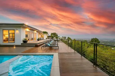 a villa with a swimming pool and a house at Stunning Modern Estate in BH with Pool, Spa, and Views in Los Angeles