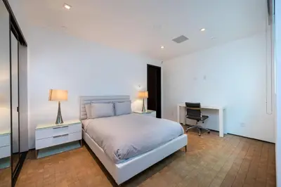 a white bedroom with a bed and a desk and a desk at Ultra Luxurious Villa in the Beverly Hills Flats in Los Angeles
