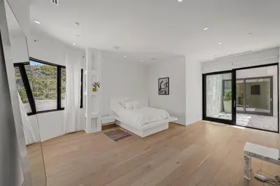 a white living room with a white couch and windows at Prestigious 6BR BH Mansion W. Pool, Theatre, Views in Los Angeles