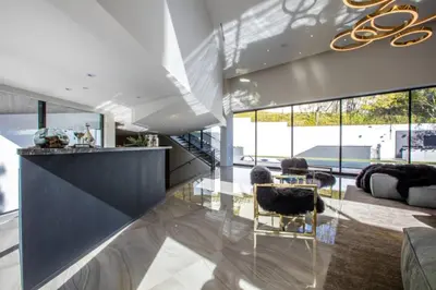a living room with a glass counter and chairs at Beverly Hills Luxurious 4BR Villa with Pool and Views in Los Angeles