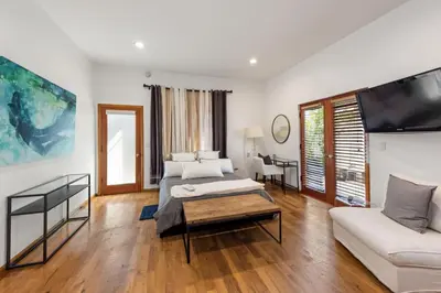 a living room with a couch and a tv at Royalty Villa in Beverly Hills in Los Angeles