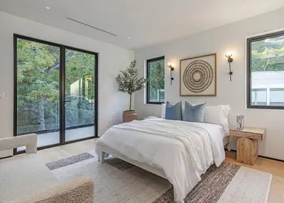 a bedroom with a large bed and large windows at Sunset Plaza Luxury Masterpiece Villa in Los Angeles