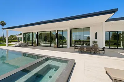 a large house with a swimming pool in front of it at Ultra Luxurious 5BR Villa W. Pool, Jacuzzi, Views in Los Angeles