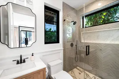 a bathroom with a shower and a toilet and a sink at Stunning 6BR Laurel Canyon Estate with Pool and Jacuzzi in Los Angeles