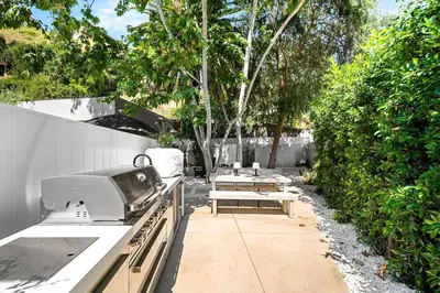 a patio with a stove and a table and a grill at Stunning 6BR Laurel Canyon Estate with Pool and Jacuzzi in Los Angeles