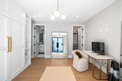 a white living room with a desk and a mirror at Stunning 6BR Laurel Canyon Estate with Pool and Jacuzzi in Los Angeles