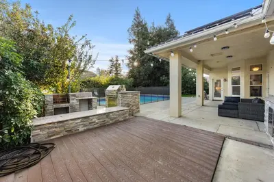 a patio with a grill and a fire pit at Corporate & Family Retreat Seven Oaks Pool Home in Bakersfield