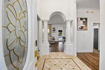 a hallway with a door with a gold finish at Corporate & Family Retreat Seven Oaks Pool Home in Bakersfield