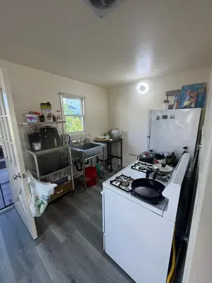 a kitchen with a stove and a white refrigerator at 262 Coronado ave in Long Beach