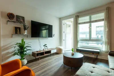 a living room with a couch and a table at Modern Serenity Apartment for a Comfortable Stay in Glendale