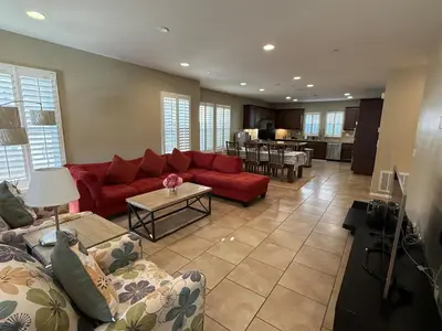 a living room with a red couch and a table at Shopping at Arcadia Mall, Homes, School District, Comfortable Home on Huntington Road in Arcadia