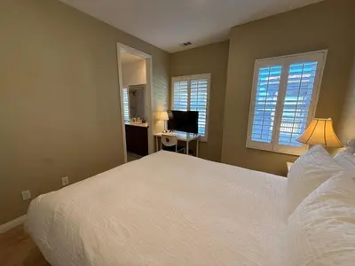 a bedroom with a bed and a desk with a computer at Shopping at Arcadia Mall, Homes, School District, Comfortable Home on Huntington Road in Arcadia