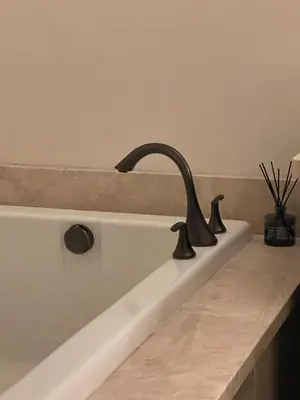 a bath tub with a black faucet in a bathroom at Shopping at Arcadia Mall, Homes, School District, Comfortable Home on Huntington Road in Arcadia