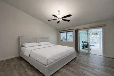 a bedroom with a bed and a ceiling fan at Luxury 4 Bedroom Home Pool Big Yard San Bernardino in San Bernardino