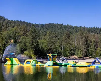 a group of inflatable play structures on a lake at Luxury 4 Bedroom Home Pool Big Yard San Bernardino in San Bernardino
