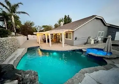 a swimming pool in front of a house at Luxury 4 Bedroom Home Pool Big Yard San Bernardino in San Bernardino