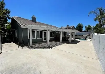 a house with a large driveway in front of it at Luxury 4 Bedroom Home Pool Big Yard San Bernardino in San Bernardino