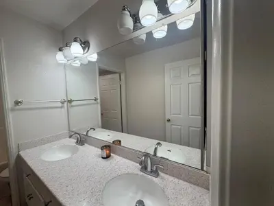 a bathroom with two sinks and a large mirror at Luxury 4 Bedroom Home Pool Big Yard San Bernardino in San Bernardino