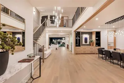 a large living room with a staircase and a dining room at Studio City Luxury 6BR Home with Pool and Theatre in Los Angeles