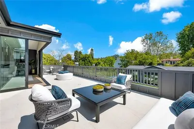 a patio with chairs and a table on a balcony at Studio City Luxury 6BR Home with Pool and Theatre in Los Angeles