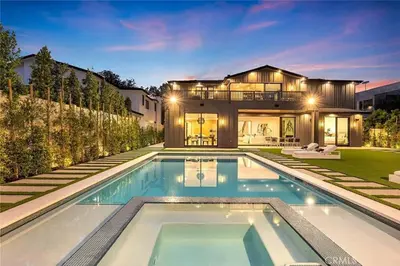 a house with a swimming pool in front of a house at Studio City Luxury 6BR Home with Pool and Theatre in Los Angeles