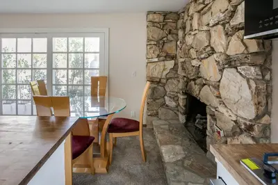 a kitchen with a table and a stone wall at Cozy 1BR Guest House with Mountain View in Simi Valley in Simi Valley